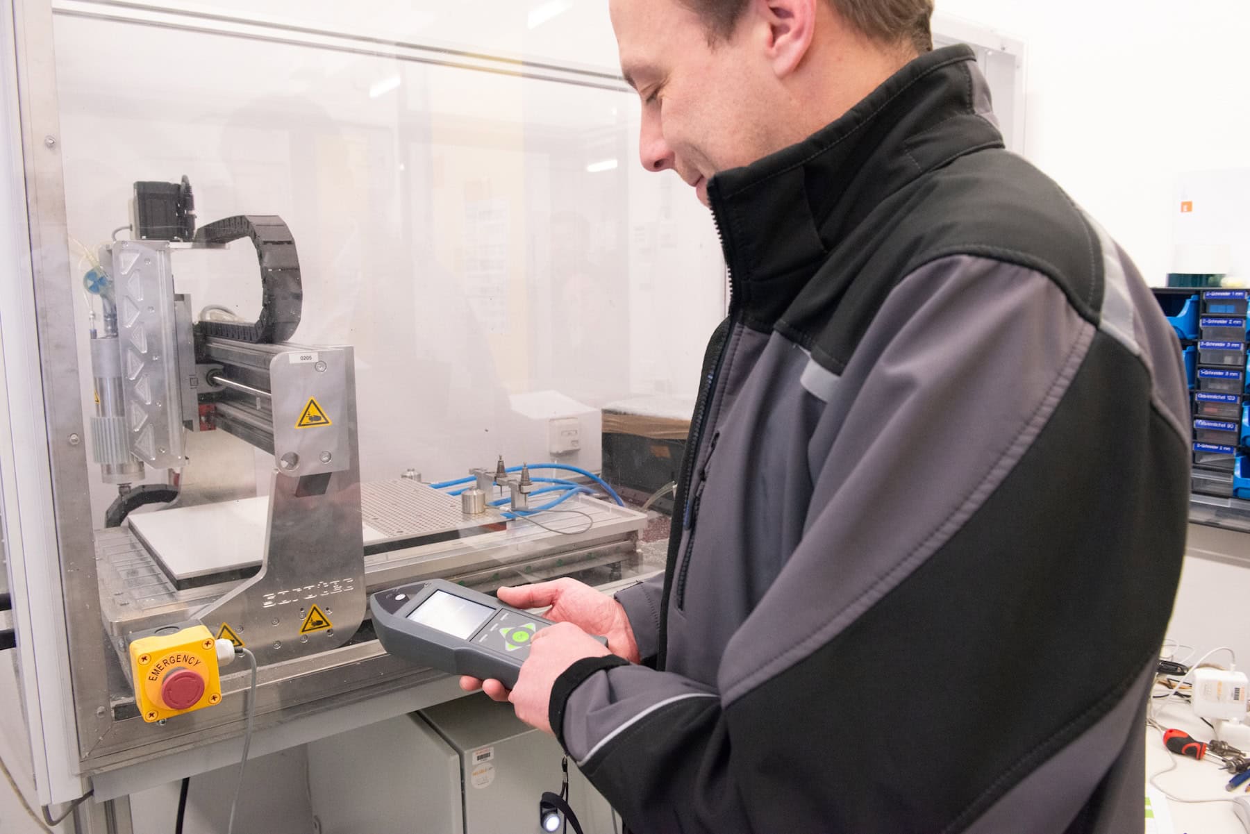 A consultant is taking measurements on a piece of plant using a handheld meter