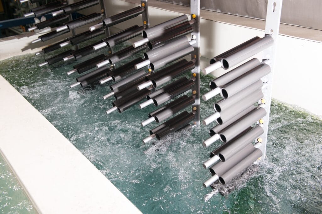 Goods rack with tubes in the bath of an electroplating plant